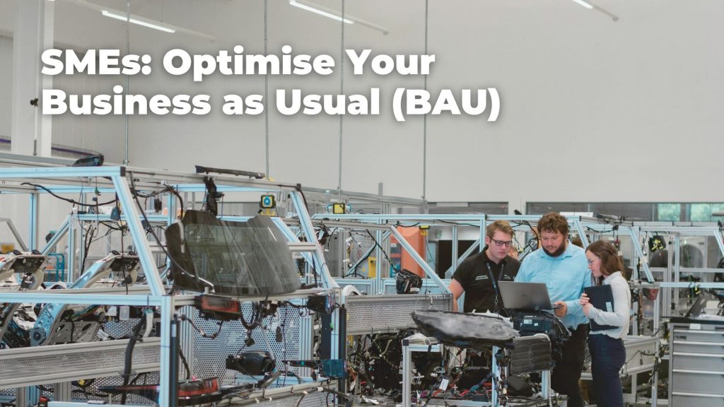 a group of people discussing how to optimise their business operation in a factory