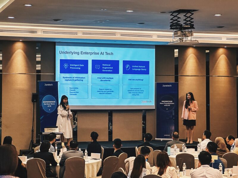 Two women speaking to an audience.