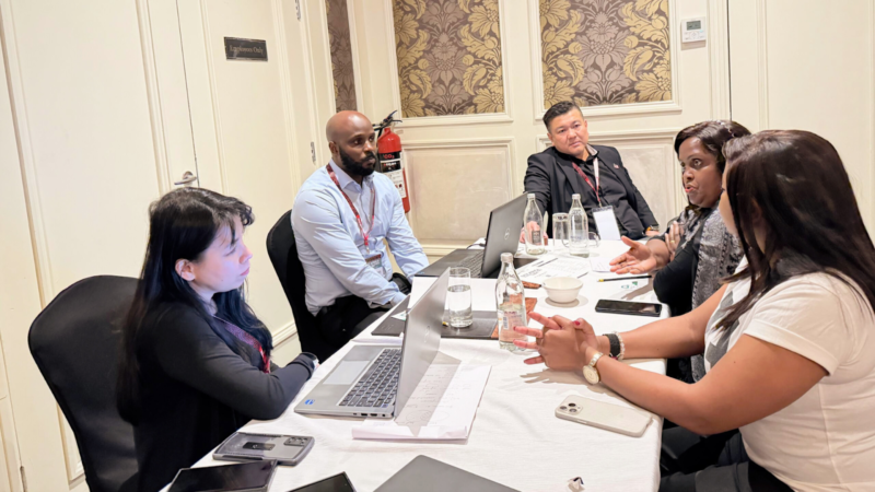 Five people having a discussion during a business matching session at the East Africa Banking Solutions Summit.